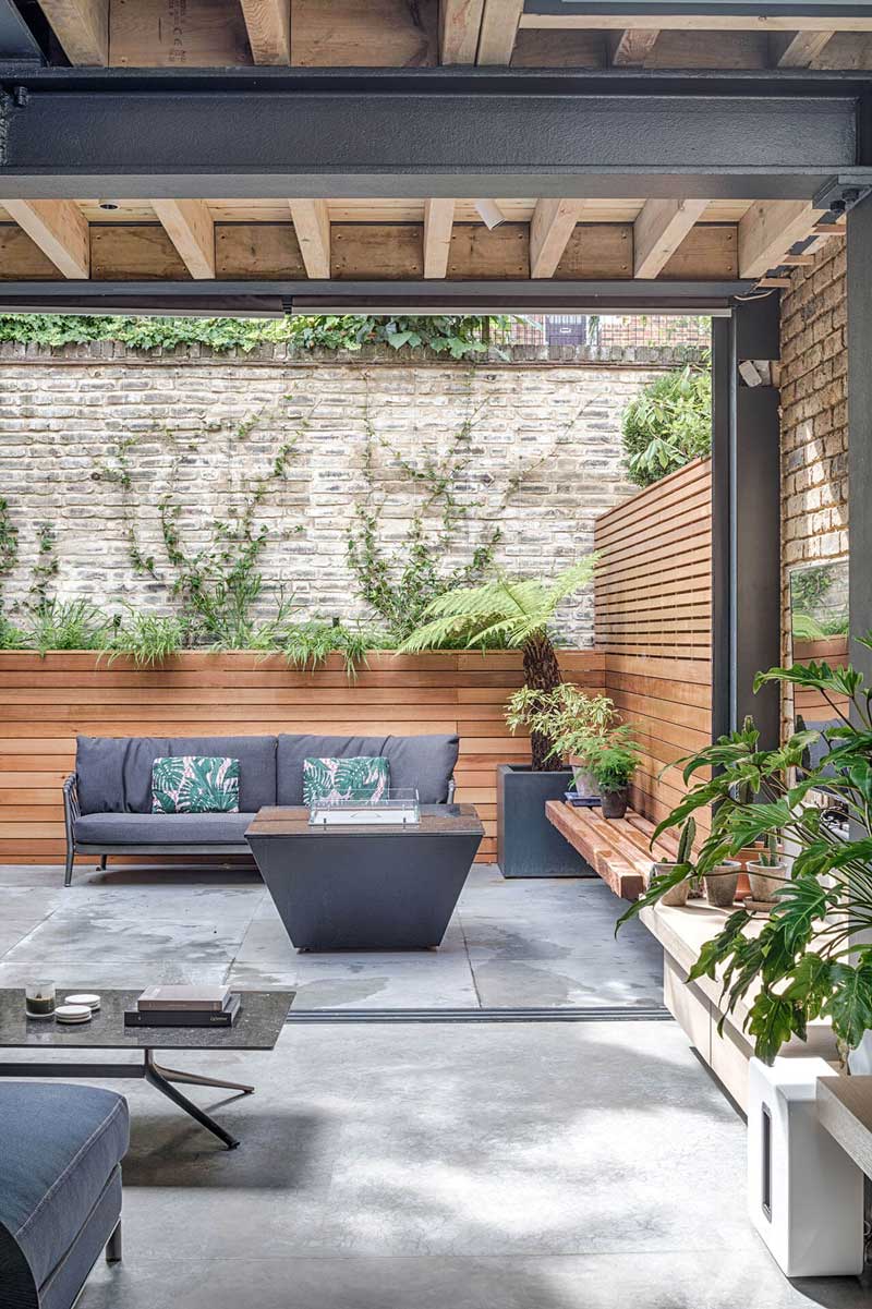 Grand Grey Shaker Kitchen with living area opening onto the garden with slatted wooden planters and outdoor seating