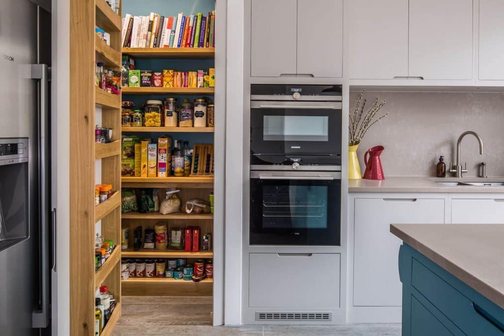 Contemporary kitchen with walk in larder and food racks