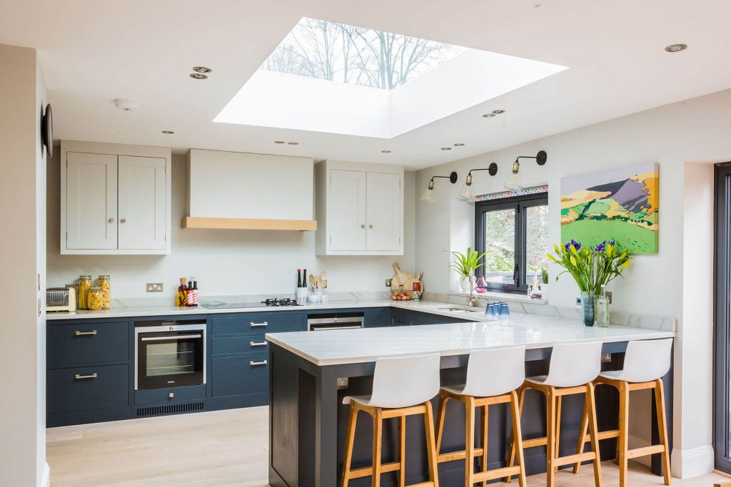 Light and airy london Shaker kitchen with large peninsular and white quartz worktop