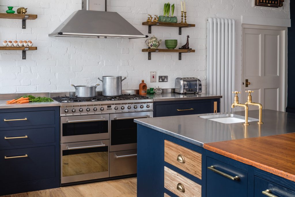 Eco Extension Shaker Kitchen with exposed whie brick wall, vintage homewares and navy cabinetry